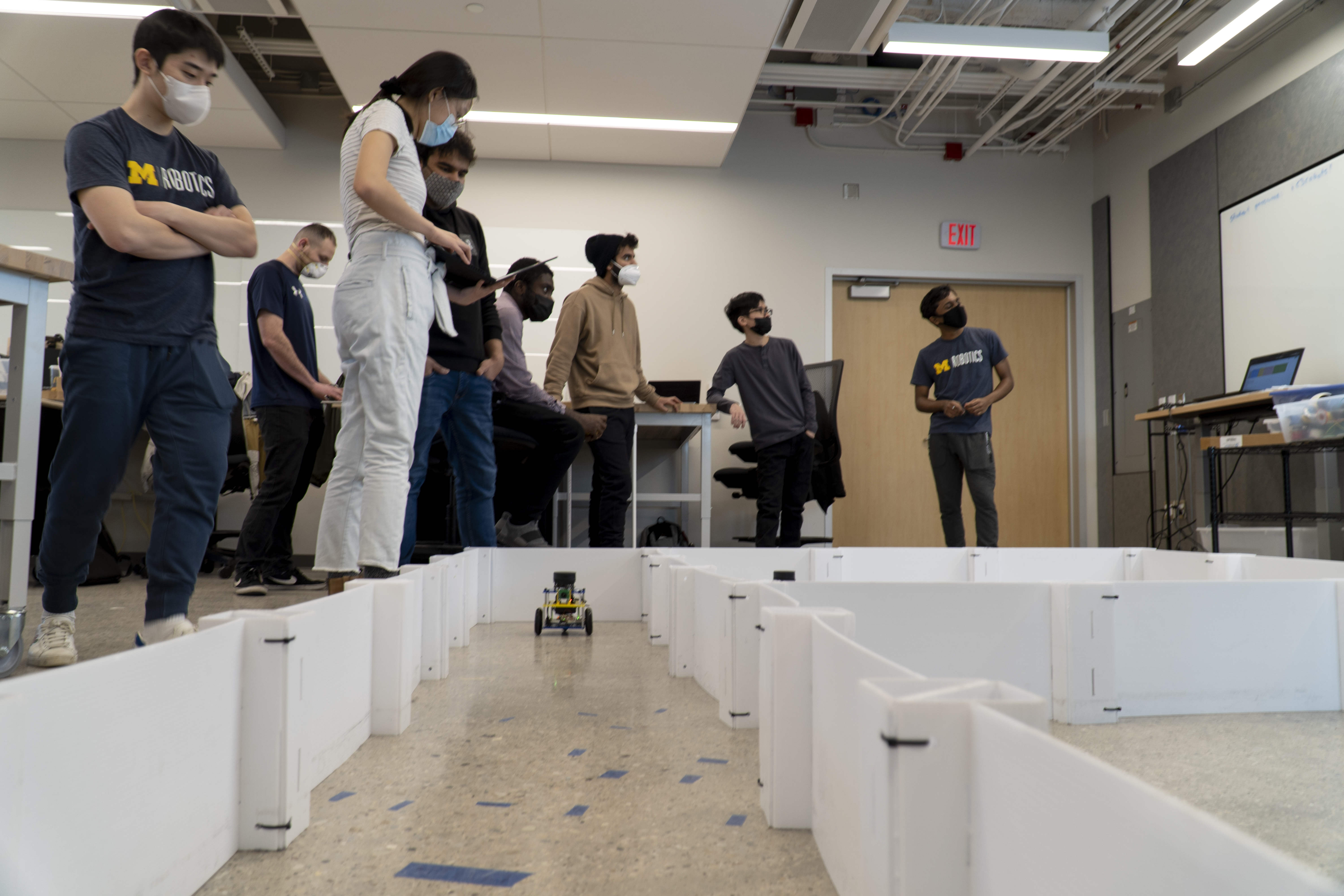 Students watch as their robots compete in pathfinding competitions
